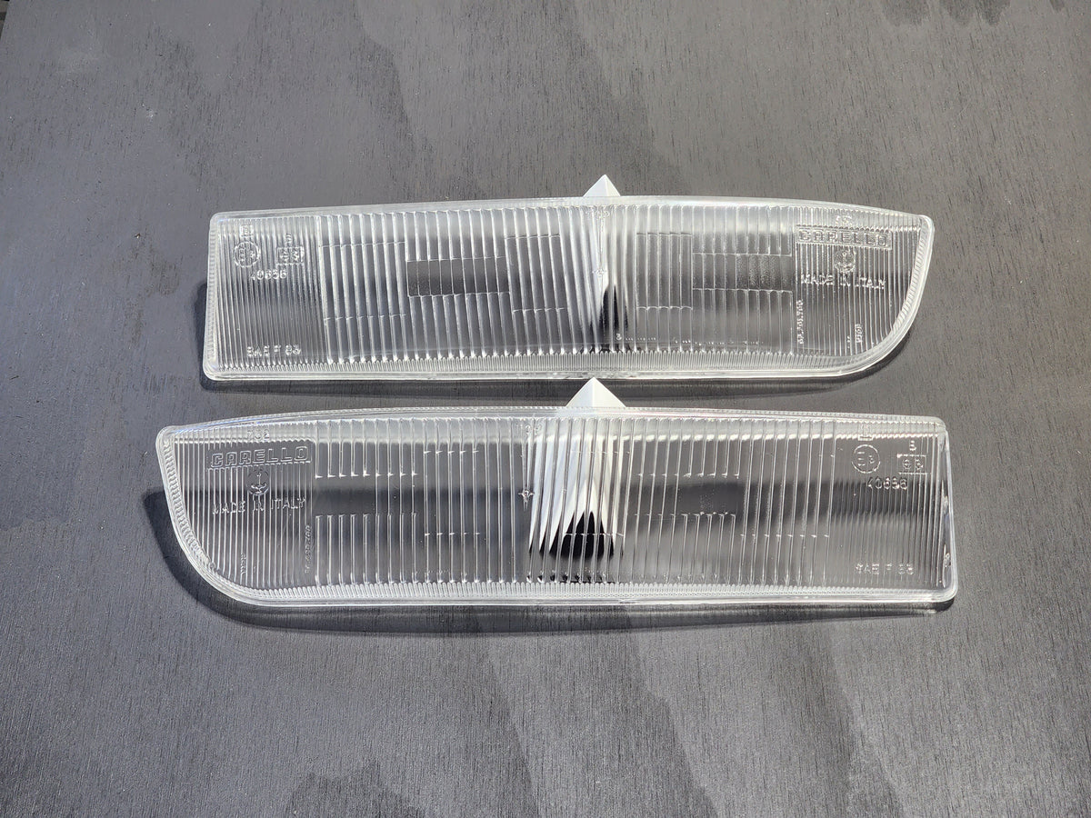 A set of two clear front fog lenses for a Ferrari Testarossa.